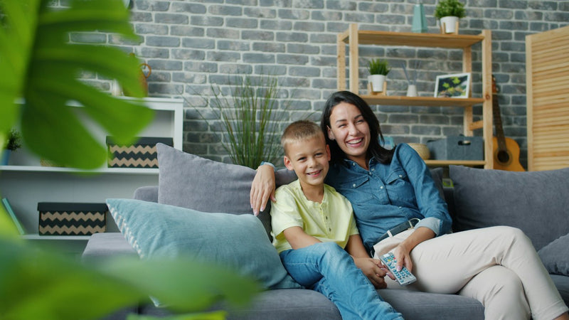 kleo-motherson | Mother and son smiling on a couch