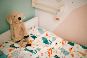 kleo-plush | Stuffed toy dog on a child's bed